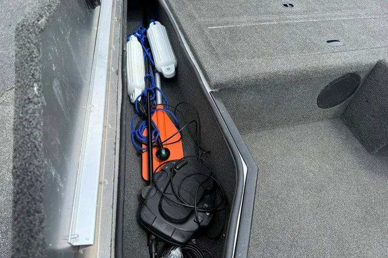 Slide: The Image of Storage compartment of a 2014 Lowe Stinger 175 boat with boating accessories. - 15