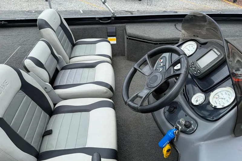 Slide: The Image of Interior of a 2014 Lowe Stinger 175 boat with steering wheel and gauges. - 10