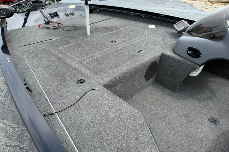 Slide: The Image of 2014 Lowe Stinger 175 boat interior with carpeted deck and control panel. - 14