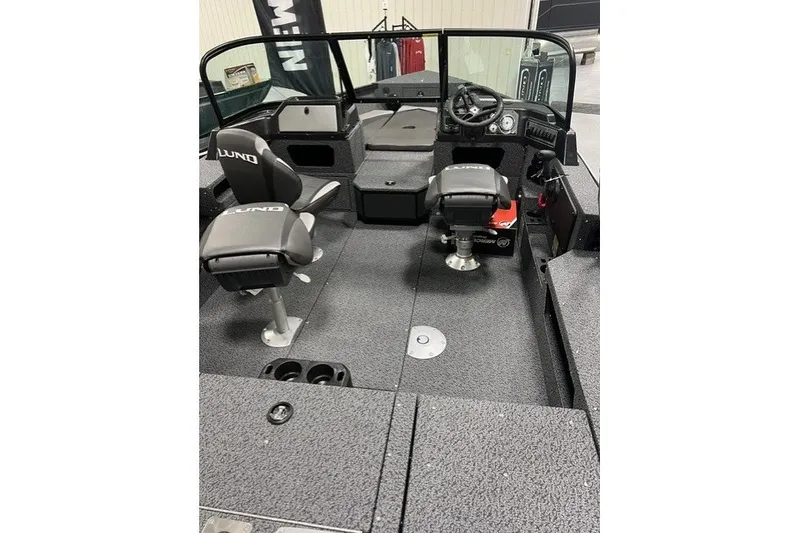 Slide: The Image of 2027 Lund 1875 Impact XS boat interior with seating and steering console. - 3