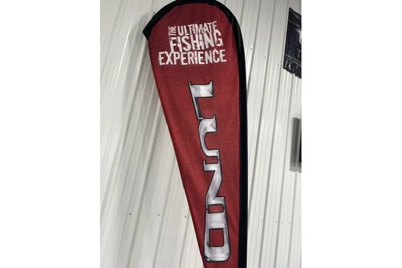 Slide: The Image of Red Lund banner promoting "The Ultimate Fishing Experience" for 2027 Lund 1875 Impact XS. - 17