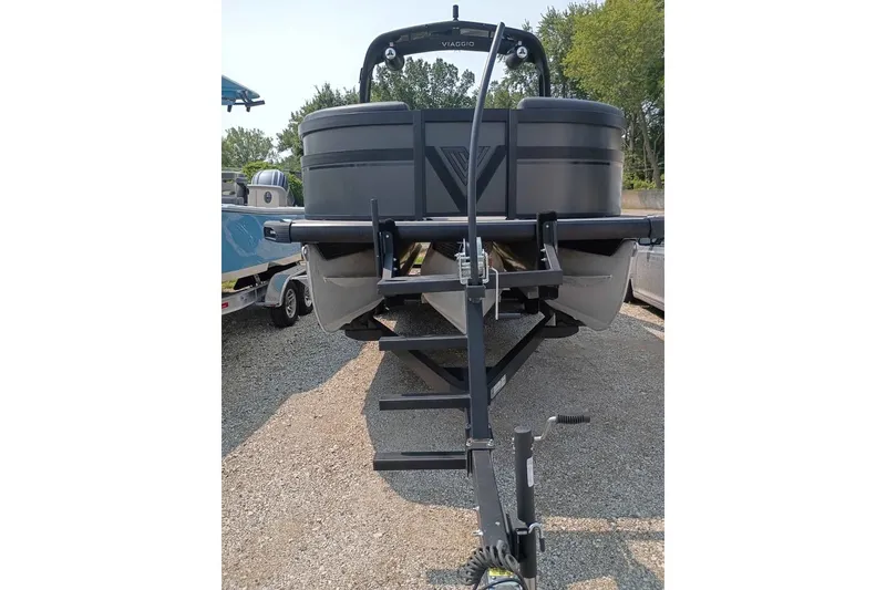 Slide: The Image of 2024 Viaggio Diamante U 22 pontoon boat on trailer, parked outdoors. - 2