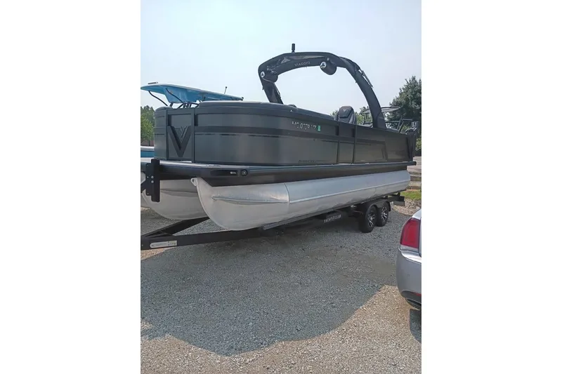 Slide: The Image of 2024 Viaggio Diamante U 22 pontoon boat on trailer, parked outdoors. - 1