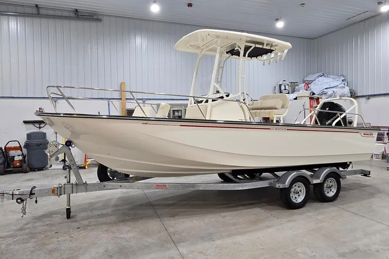 The Image of 2026 Montauk 210 boat on trailer in indoor storage facility. - 1