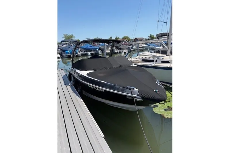 Slide: The Image of 2018 Regal 2300 Bowrider boat docked with cover in marina. - 2