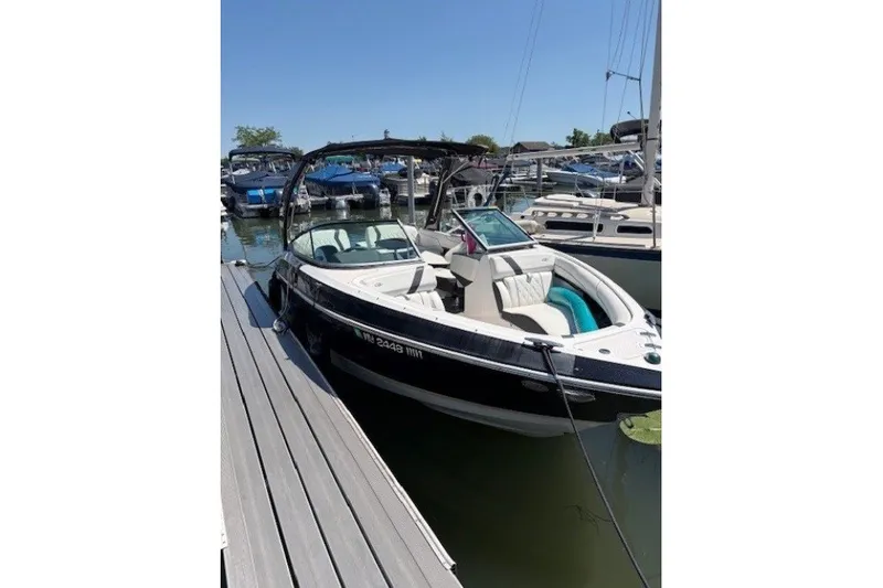 The Image of 2018 Regal 2300 Bowrider docked at marina, sleek design, sunny day. - 1