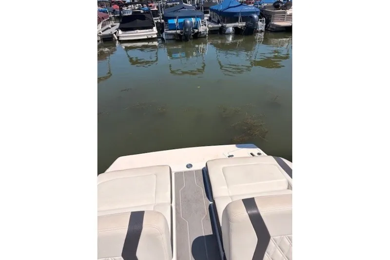 Slide: The Image of 2018 Regal 2300 Bowrider boat interior with marina view in background. - 10
