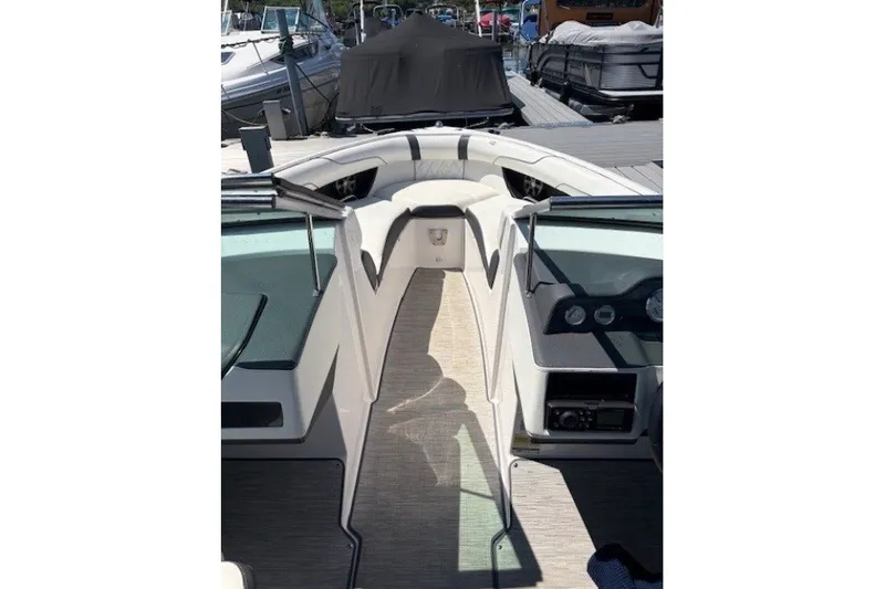 Slide: The Image of 2018 Regal 2300 Bowrider interior view at dock, showcasing seating and dashboard. - 7