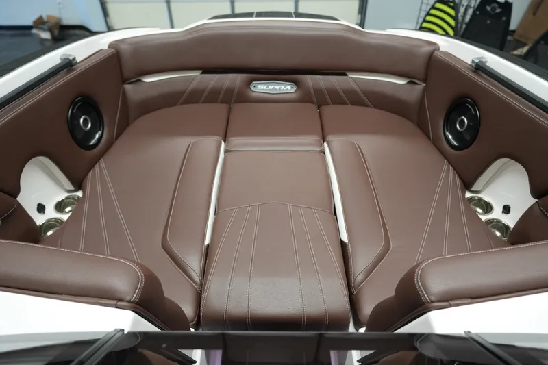 Slide: The Image of 2024 Supra SA 450 boat interior with brown leather seating and integrated speakers. - 21
