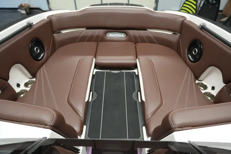 Slide: The Image of 2024 Supra SA 450 boat interior with brown leather seating and integrated speakers. - 20