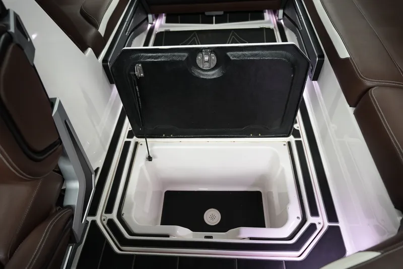 Slide: The Image of 2024 Supra SA 450 boat interior storage compartment with open lid, showcasing sleek design. - 22
