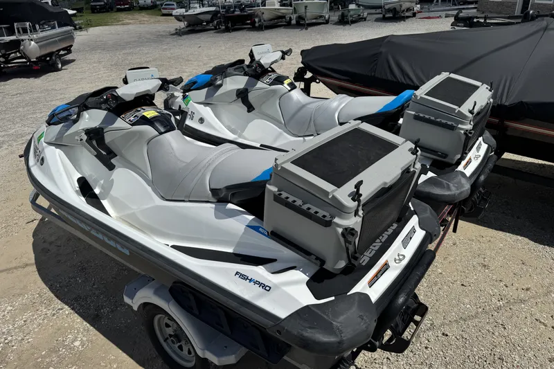 Slide: The Image of 2022 Sea-Doo FishPro Scout 130 jet skis with storage boxes on a trailer. - 2