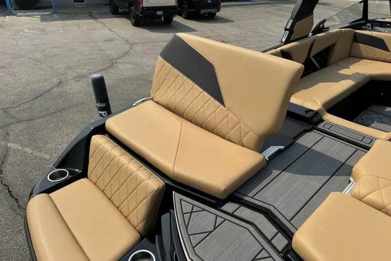 Slide: The Image of 2022 Tigé Z3 boat interior with tan diamond-stitched seats and cup holders. - 14