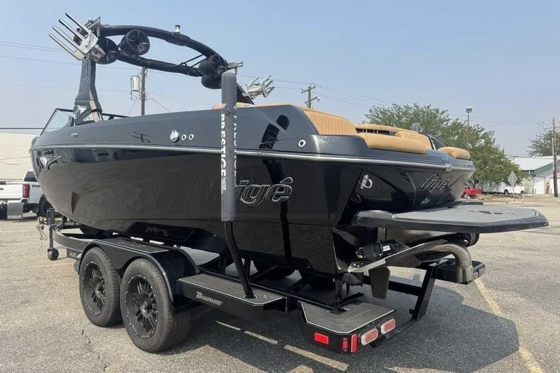 Slide: The Image of 2022 Tigé Z3 boat on trailer, sleek black design, parked outdoors. - 13