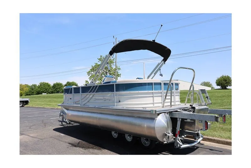Slide: The Image of 2025 South Bay 220 RS LE 2.75 pontoon boat with canopy on trailer. - 6
