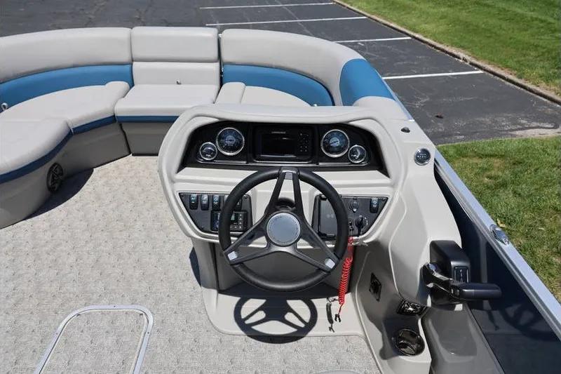 Slide: The Image of Cockpit of 2025 South Bay 220 RS LE 2.75 pontoon boat with steering wheel and controls. - 15