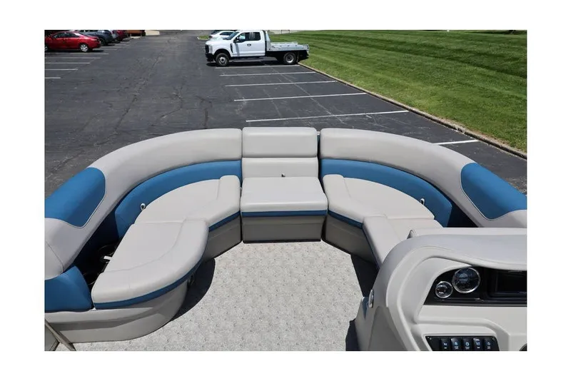 Slide: The Image of 2025 South Bay 220 RS LE 2.75 pontoon boat with spacious seating in a parking lot. - 14