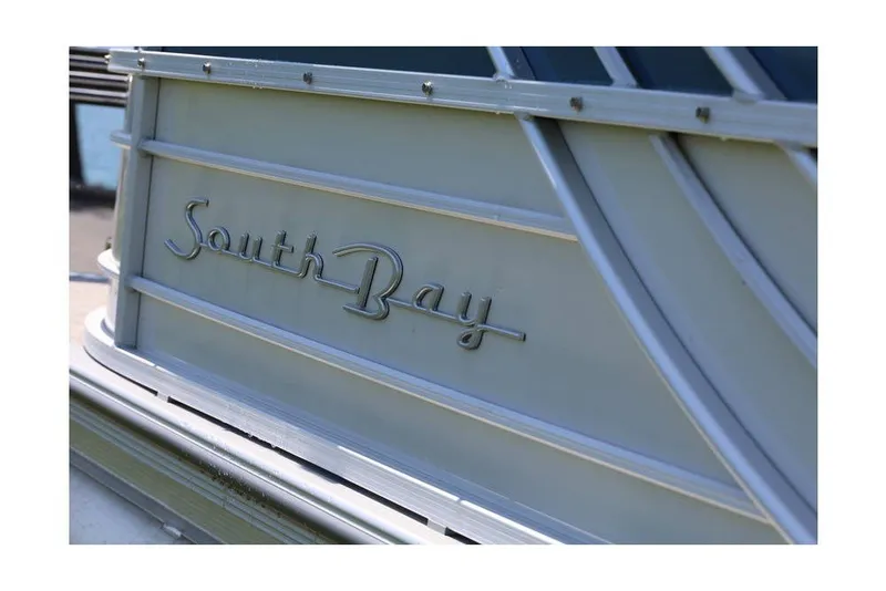 Slide: The Image of Close-up of 2025 South Bay 220 RS LE 2.75 boat logo on metallic surface. - 20