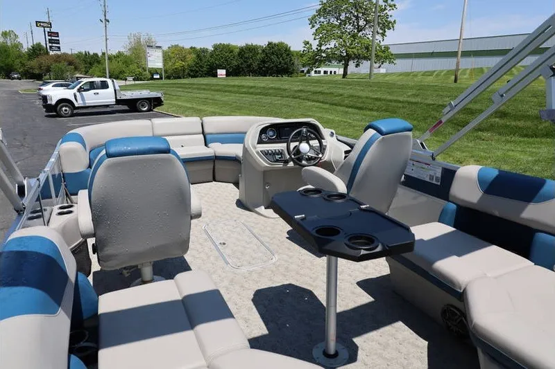 Slide: The Image of 2025 South Bay 220 RS LE 2.75 pontoon boat interior with seating and steering console. - 18