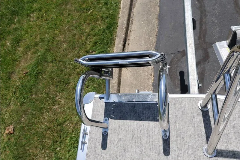 Slide: The Image of 2025 South Bay 220 RS LE 2.75 boat ladder on deck, near grass and pavement. - 17