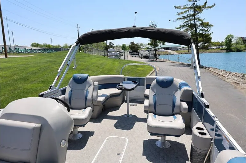 Slide: The Image of 2025 South Bay 220 RS LE 2.75 pontoon boat interior with seating and canopy. - 10