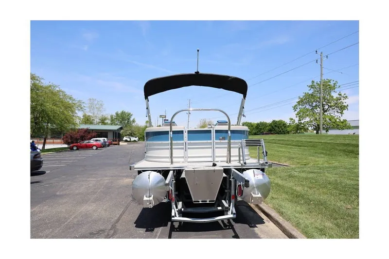 Slide: The Image of 2025 South Bay 220 RS LE 2.75 pontoon boat parked outdoors. - 7
