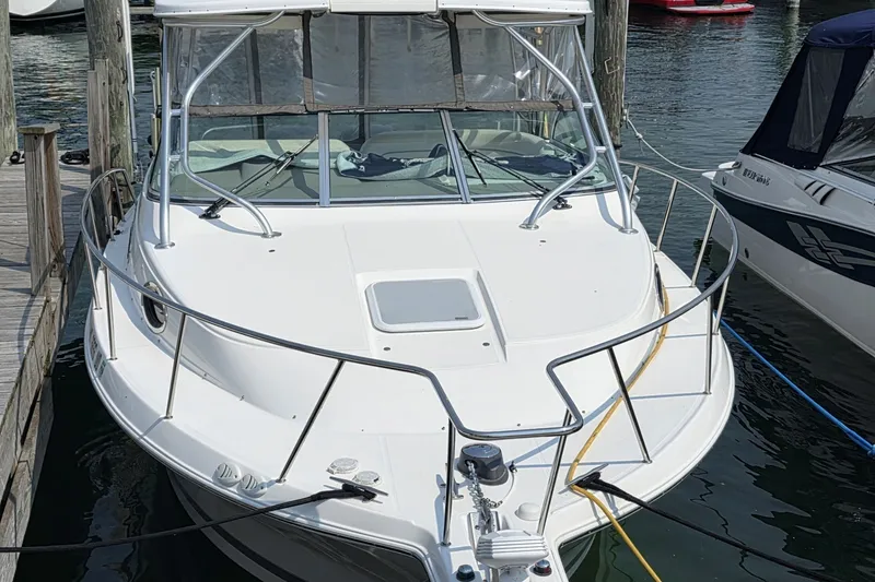 Slide: The Image of 2005 Wellcraft 290 Coastal boat docked at marina, front view. - 2