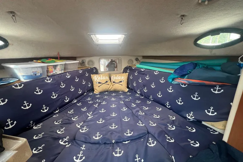 Slide: The Image of Cozy cabin interior of 2005 Wellcraft 290 Coastal with nautical-themed bedding and decor. - 10