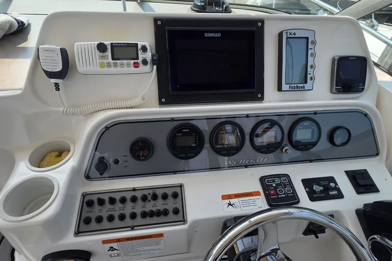 Slide: The Image of Control panel of a 2005 Wellcraft 290 Coastal boat with navigation and communication equipment. - 13