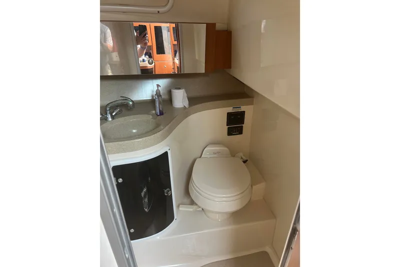 Slide: The Image of 2005 Wellcraft 290 Coastal boat bathroom with sink, mirror, and toilet. - 9