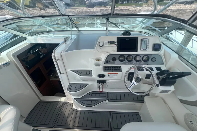 Slide: The Image of 2005 Wellcraft 290 Coastal boat cockpit with steering wheel and control panel. - 4