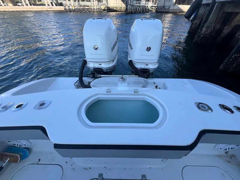 Slide: The Image of 2017 Conch 30 boat with dual engines, docked by the water. - 13