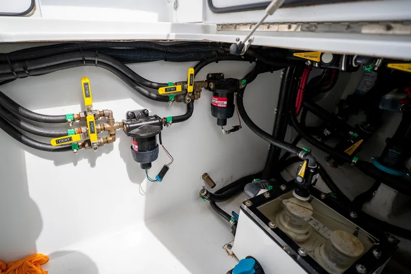 Slide: The Image of Engine compartment of 2025 Contender 39 ST boat, showcasing hoses and valves. - 57