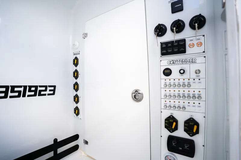 Slide: The Image of Control panel of 2025 Contender 39 ST boat, featuring switches and gauges. - 55