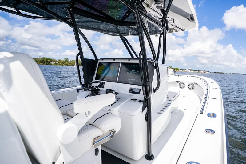Slide: The Image of 2025 Contender 39 ST boat interior with modern helm and navigation system on open water. - 29