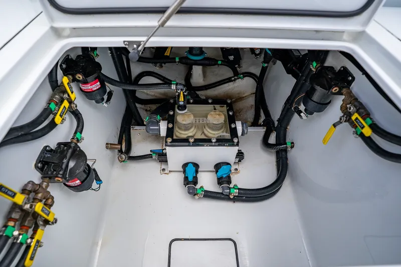 Slide: The Image of 2025 Contender 39 ST boat engine compartment with hoses and valves. - 56