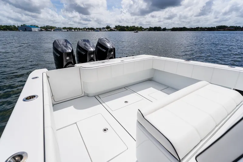 Slide: The Image of 2025 Contender 39 ST boat with triple Mercury engines on a calm lake. - 42
