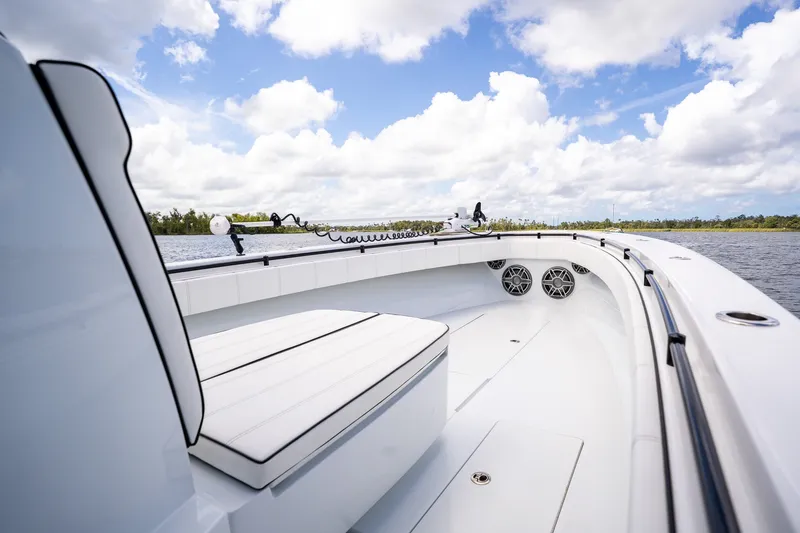 Slide: The Image of 2025 Contender 39 ST boat interior with white seating and clear blue sky. - 14