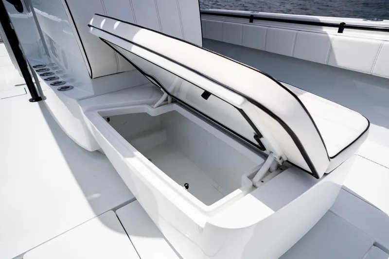 Slide: The Image of Open storage compartment on 2025 Contender 39 ST boat, featuring sleek white seating. - 22