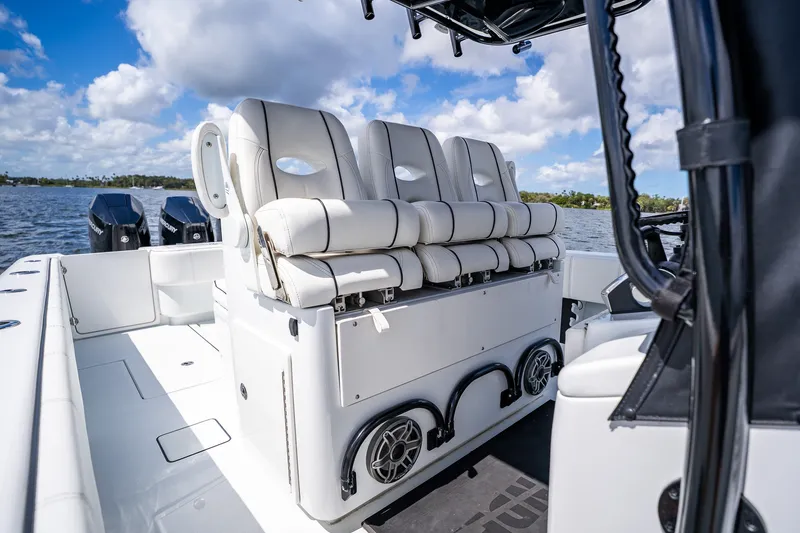Slide: The Image of 2025 Contender 39 ST boat interior with cushioned seating and dual outboard motors. - 27