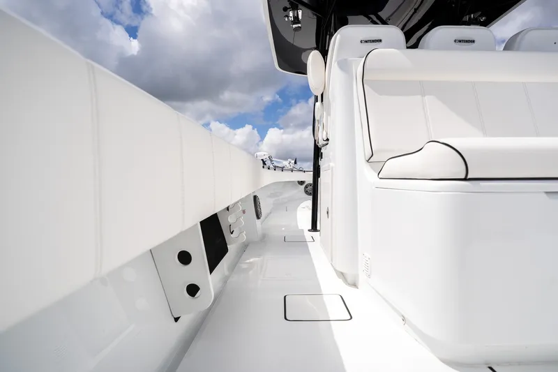 Slide: The Image of 2025 Contender 39 ST boat interior with sleek white seating and modern design. - 38