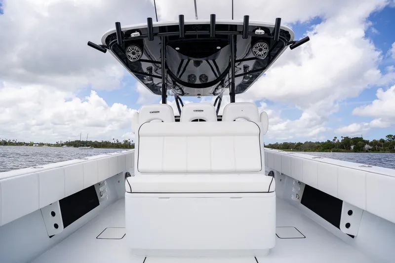 Slide: The Image of 2025 Contender 39 ST boat interior with white seating and sleek design on open water. - 37