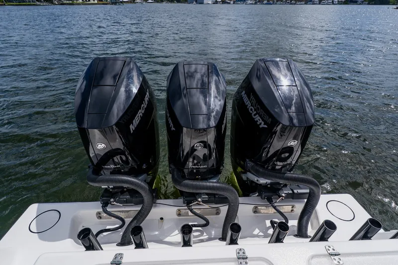 Slide: The Image of Triple Mercury outboard engines on a 2025 Contender 39 ST boat in water. - 49