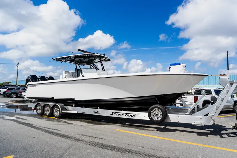 Slide: The Image of 2025 Contender 39 ST boat on trailer under blue sky. - 59