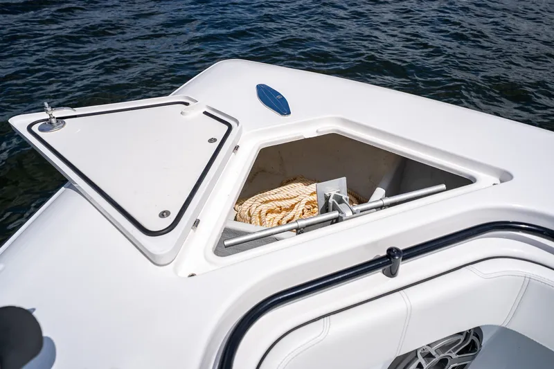 Slide: The Image of Open storage compartment on 2025 Contender 39 ST boat with rope inside. - 15