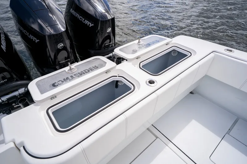 Slide: The Image of 2025 Contender 39 ST boat with Mercury Verado engines and open storage compartments. - 48