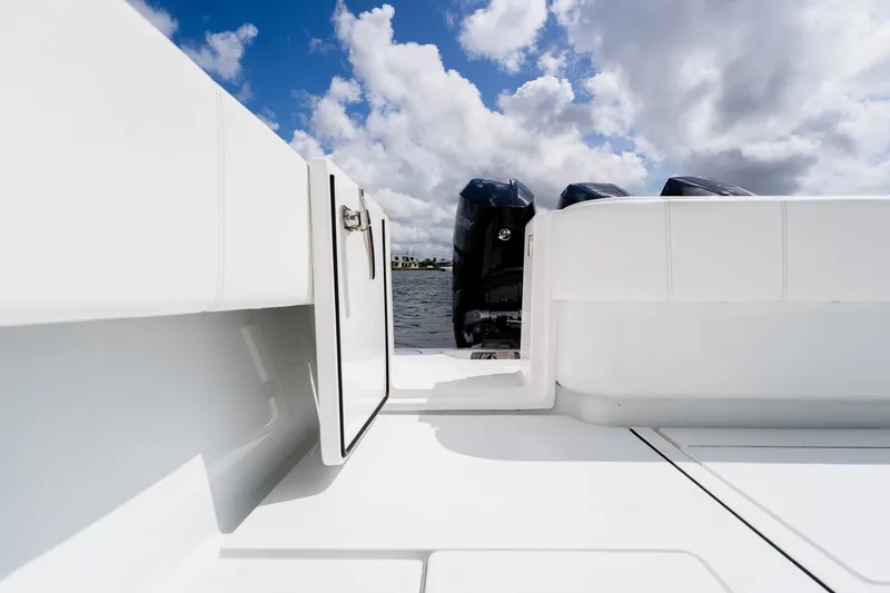 Slide: The Image of 2025 Contender 39 ST boat deck with outboard motors under cloudy sky. - 53