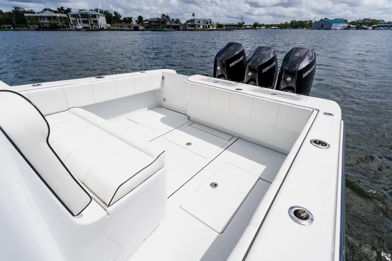 Slide: The Image of 2025 Contender 39 ST boat with triple Mercury engines on a calm lake. - 43