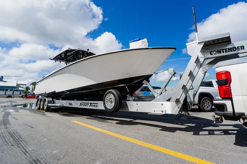 Slide: The Image of 2025 Contender 39 ST boat on trailer, parked on sunny day. - 60