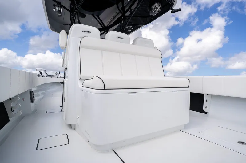 Slide: The Image of 2025 Contender 39 ST boat interior with white seating against a blue sky backdrop. - 40